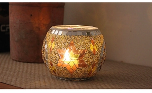Detailed view of mosaic glass candle holder with star patterns and gold beads