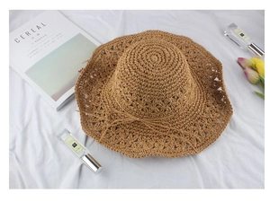 Detailed star-patterned weave and bow knot on khaki straw sun hat for beach vacations