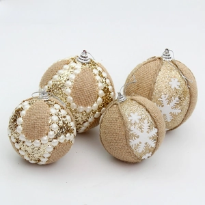 Detail of burlap Christmas balls with white pearls, glitter, and snowflake patterns