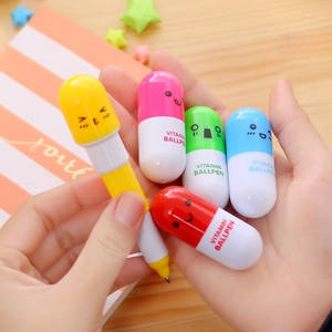 Macro detail of various colorful pill-shaped capsule ballpoint pens with cute faces