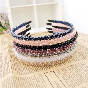 Detailed stack of multicolored crystal beaded headbands with retro aesthetic