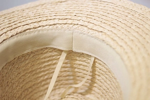 Detail of adjustable drawstring and inner grosgrain sweatband on raffia sun hat