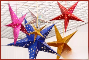 Detail of colorful laser paper star lanterns with moon and star hollow-out patterns