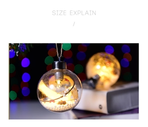 Close-up of lighted 8cm Christmas ball with warm LED lights and white foam snow beads