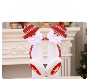 Close-up of Christmas ear muffs with knitted stripes, white faux fur, and Santa figures
