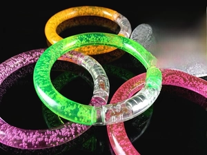 Close-up of LED glowing acrylic bubble bracelets in multiple vibrant neon colors