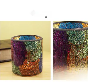 Detail of European mosaic glass candle holder with colorful pattern and warm lighting