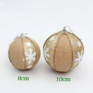 Detail view of 8cm and 10cm burlap Christmas balls with white snowflake patterns