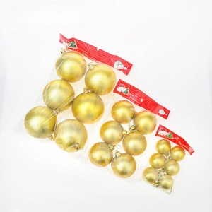 Three packs of gold matte Christmas tree ornaments in different sizes with festive header