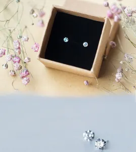 Macro detail of S925 sterling silver stud earrings with round brilliant diamonds in gift box