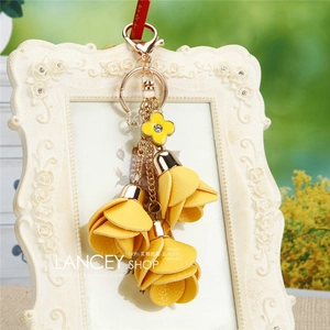 Detail of yellow leather flower petal tassels and rhinestone floral charm on keychain