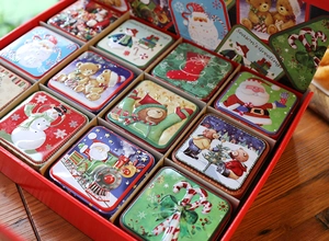 Tinplate Christmas gift box set with festive Santa and snowman patterns in a red case
