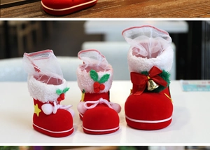 Three red velvet Christmas boots with white faux fur and festive ornaments in various sizes