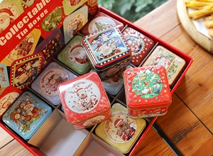 Detailed view of Christmas tin box set with hand-drawn festive Santa and reindeer designs