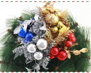 Close-up of festive Christmas picks featuring colorful baubles, pine cones and needles