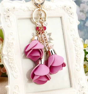 Detail of pink floral leather keychain with golden lobster clasp and crystal beads