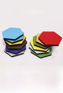 Macro detail of colorful hexagonal felt wall panels showing thickness and texture