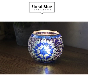 Detail of blue and white mosaic glass candle holder with blooming floral pattern