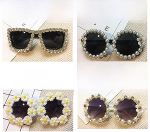 Detail view of four fashion sunglasses with floral, pearl and rhinestone embellishments