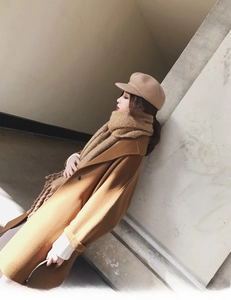 Detail of soft mohair knit scarf with chunky texture paired with a camel wool coat
