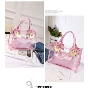 Detailed close-up of pink transparent PVC tote bag with gold lock and satin inner pouch