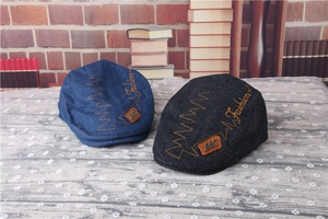 Detail of dark blue and black striped berets with Fashion embroidery and 1987 leather tag