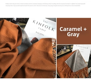 Close-up of caramel and grey double-sided cashmere scarf with soft tassel fringe details