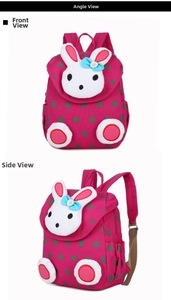 Close-up of rose red polka dot kids backpack with a 3D plush rabbit and floral bow