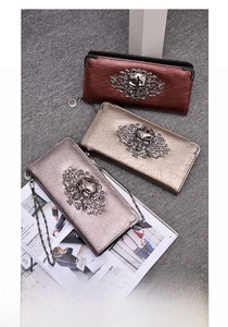 Skull embossed long zipper wallets in metallic leather showing bronze gold and silver finish