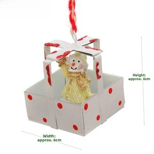 Detail of a white Christmas snowman ornament with red dots and woven hanging cord