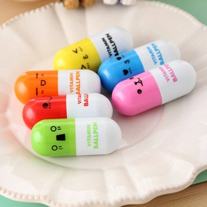 Detailed view of six colorful cartoon pill-shaped pens on a white lace plate