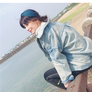 Detail of cross-knot wide headband fabric texture and light blue denim jacket design