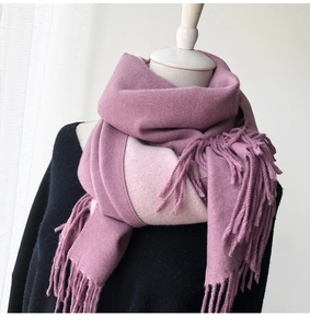 Detail of thick double-sided cashmere-feel scarf with lavender and pink hues and fringes