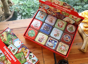 Detailed view of 12-pack Christmas collectable tin boxes with festive holiday patterns
