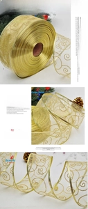 Detail of semi-transparent gold Christmas ribbon with glitter swirls for gift wrapping