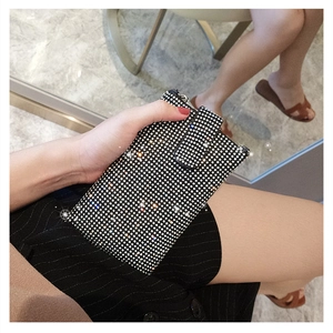 Macro shot of shimmering rhinestone mobile phone bag with durable top metal zipper closure