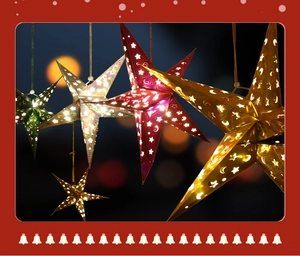 Close-up of laser-cut paper star lanterns with glowing LED lights and cutout patterns