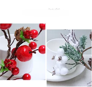 Detail of faux pine cones, red berries and snow-covered white berries for Christmas decor