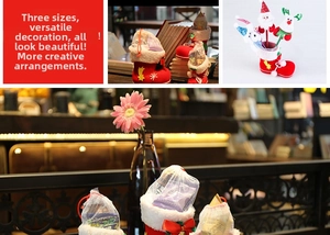 Detail of red flocked Christmas boot gift bags with white fur trim and bells in three sizes
