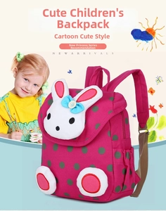 Detail of pink polka dot kids backpack featuring a cute 3D bunny plush and side pocket
