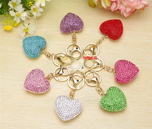 Macro view of crystal heart pompom keychains in seven colors with golden clasps