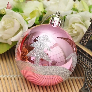 Detail of pink Christmas ornament with silver glitter tree pattern and glossy finish