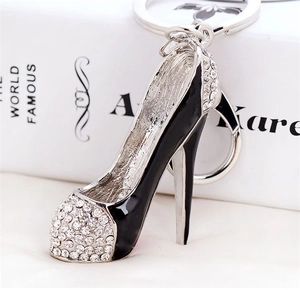 Close-up of black high heel keychain with sparkling rhinestones and silver stiletto heel
