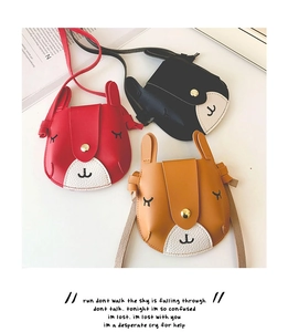 Flat lay detail of cute bunny ear crossbody bags for girls in red, black and yellow