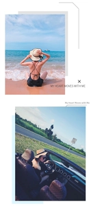 Straw sun hat with wide brim and black ribbon bow styled with an open-back swimsuit