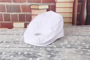 Detailed texture of kids striped beret featuring a shield badge and breathable fabric