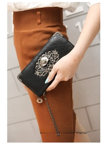 Detail of punk long wallet featuring silver skull studs and floral metal accents