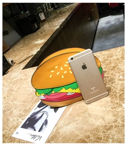 Size comparison of creative hamburger crossbody bag next to a smartphone for scale