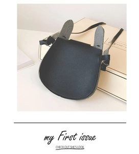 Detail of a black mini crossbody bag for kids featuring grey bunny ear decorations