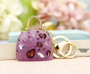 Detail of purple handbag charm with colorful crystals and gold lobster clasp and ring